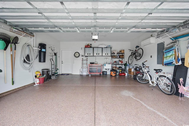 garage with a garage door opener, electric panel, and a wall mounted AC