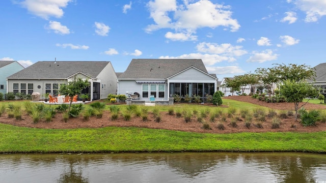 back of house with a water view and a sunroom