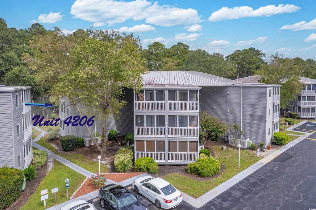 10168 Beach Dr SW Unit 4206, Calabash, NC 28467 - view of building exterior with uncovered parking