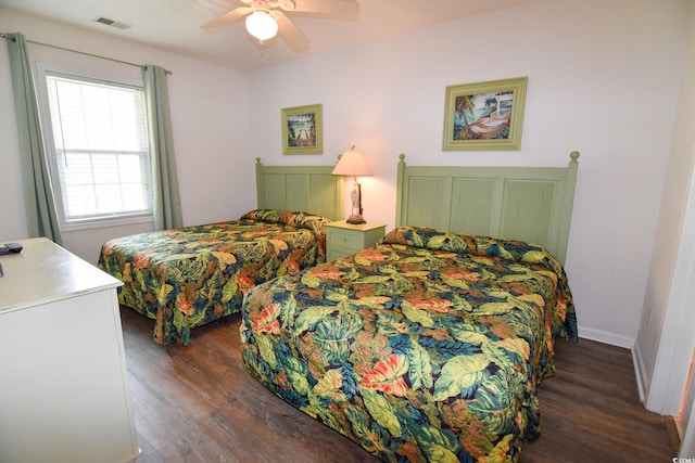 bedroom with ceiling fan and dark hardwood / wood-style flooring