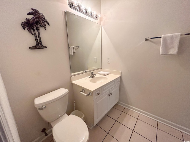 bathroom with vanity, toilet, and tile patterned floors