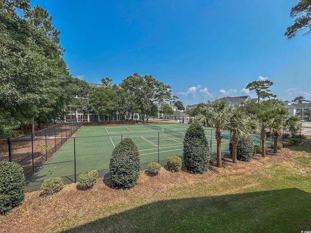 view of tennis court with a lawn