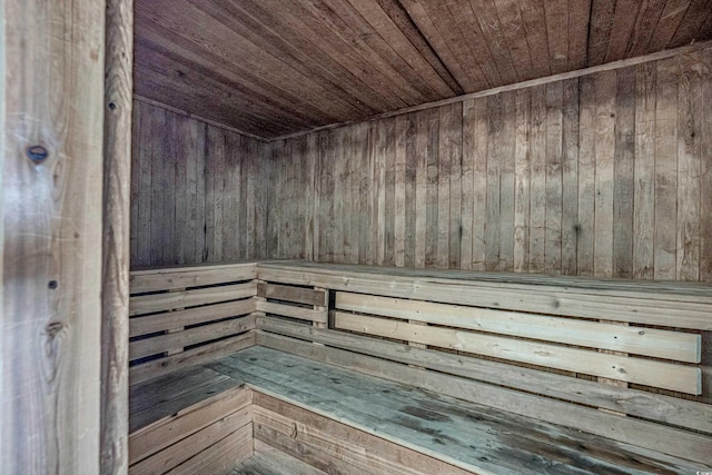 view of sauna with wood ceiling and wood walls