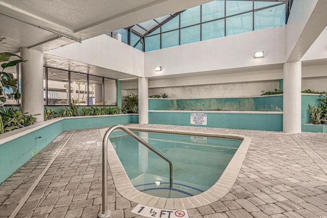 view of pool featuring a patio and an indoor hot tub