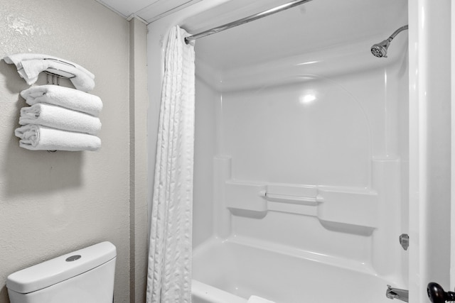 bathroom with shower / tub combo and toilet