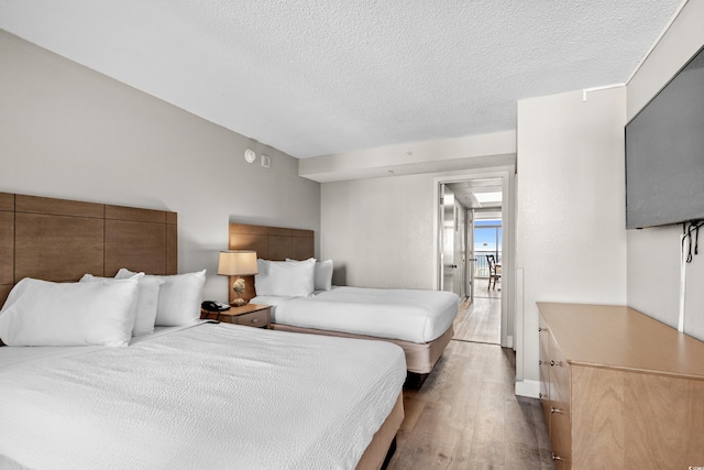 bedroom featuring a textured ceiling and hardwood / wood-style flooring