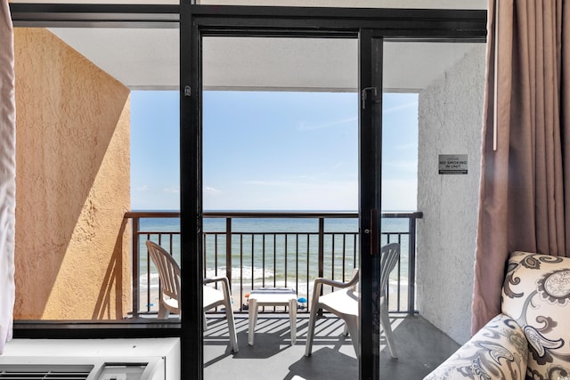 balcony with a water view and a beach view