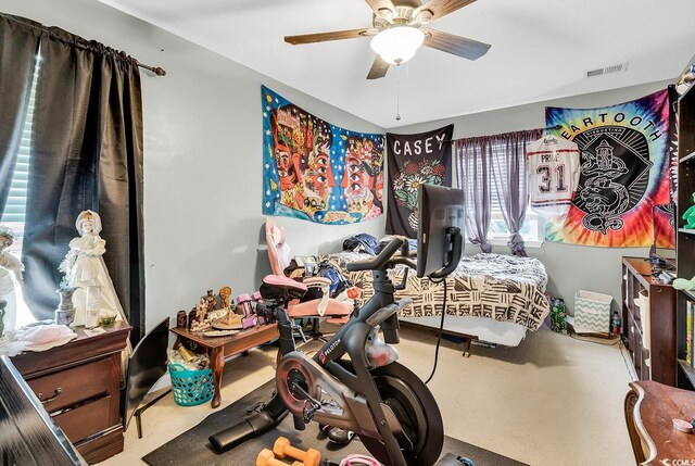 bedroom with ceiling fan, carpet, and multiple windows