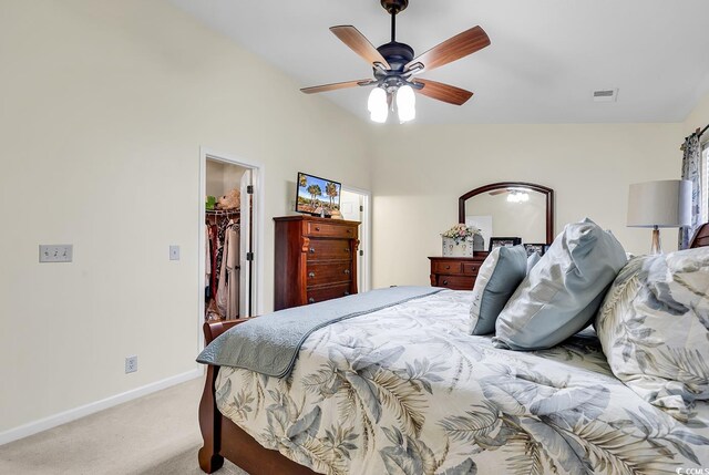 carpeted bedroom featuring a spacious closet, a closet, and ceiling fan