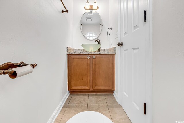 bathroom featuring tile patterned flooring, vanity, and toilet