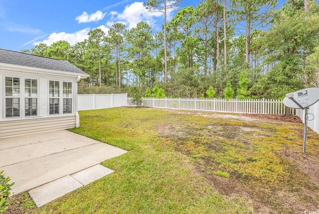 view of yard featuring a shed and a patio area