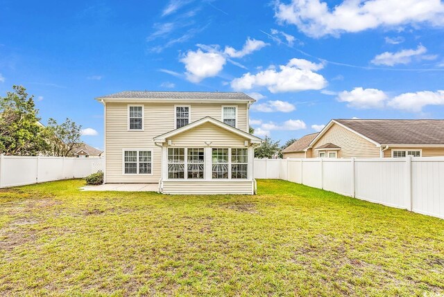 back of house with a lawn and a patio area