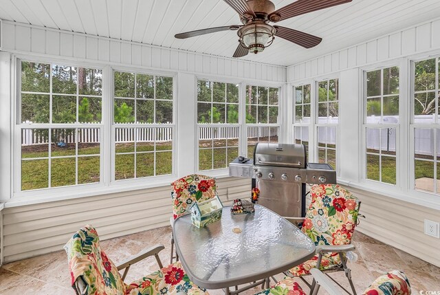 sunroom with wooden ceiling and ceiling fan