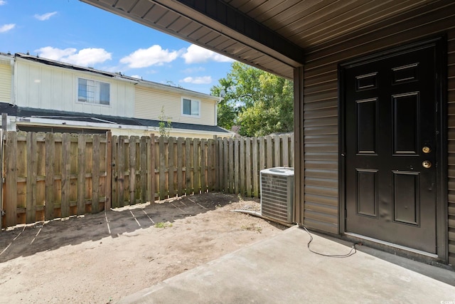 view of patio featuring fence and cooling unit