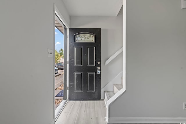 entryway with stairway and wood finished floors