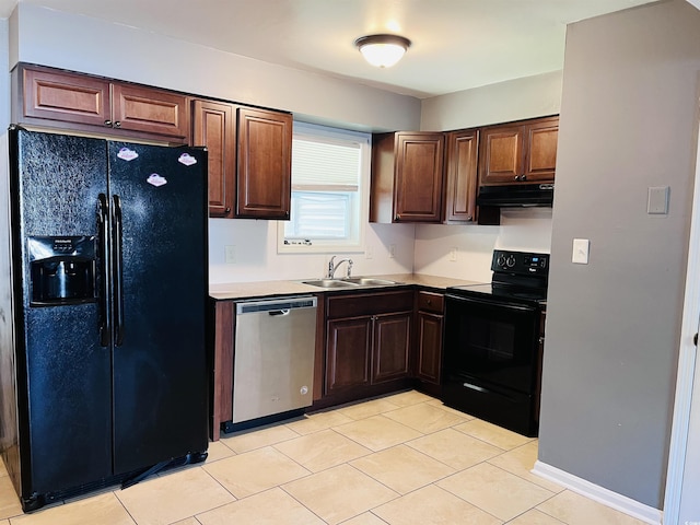 kitchen with under cabinet range hood, light countertops, black appliances, a sink, and light tile patterned flooring