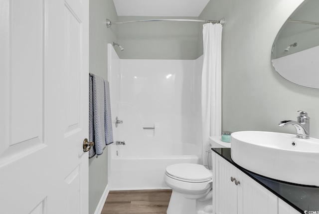 full bathroom featuring shower / bath combination with curtain, vanity, toilet, and wood finished floors