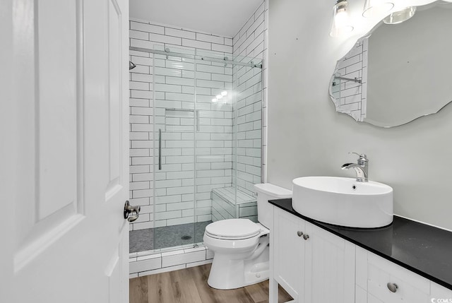 bathroom featuring an enclosed shower, hardwood / wood-style flooring, vanity, and toilet