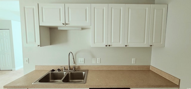 kitchen with white cabinetry and sink