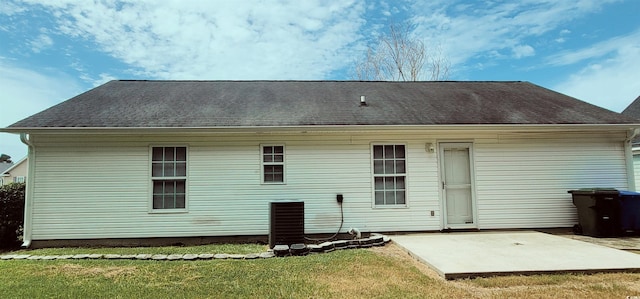 back of property featuring a lawn and a patio