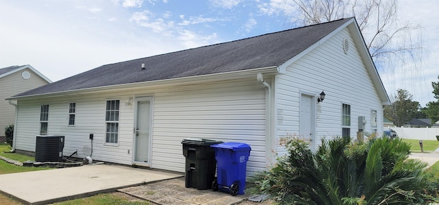 rear view of house with central AC unit and a patio area