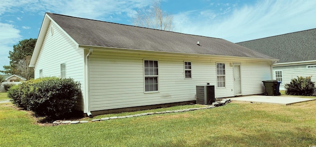 back of property with a patio, a yard, and central AC unit