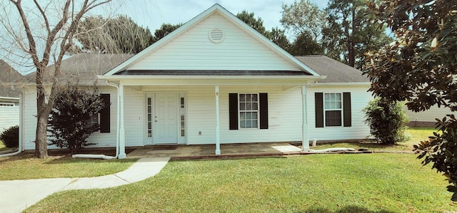 view of front facade with a front yard and covered porch