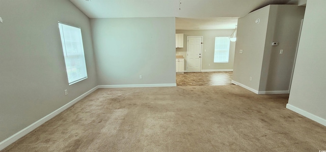 carpeted empty room featuring plenty of natural light