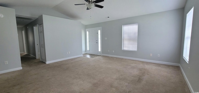 carpeted spare room with vaulted ceiling and ceiling fan