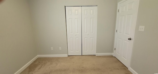 unfurnished bedroom with light colored carpet