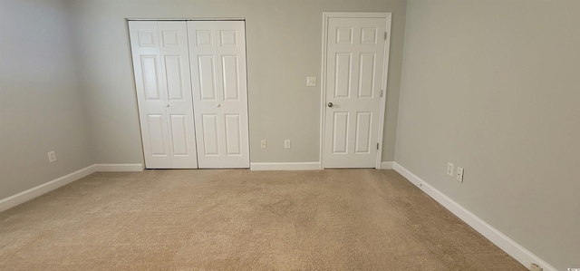 unfurnished bedroom featuring light colored carpet