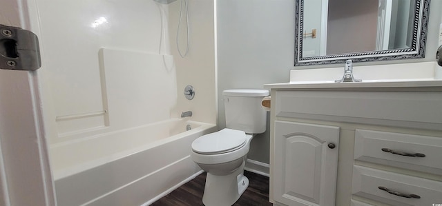 full bathroom with hardwood / wood-style flooring, shower / bath combination, vanity, and toilet