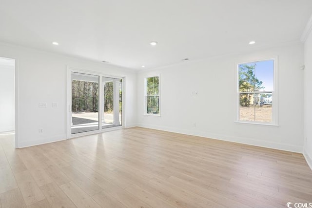 spare room featuring recessed lighting, baseboards, and light wood finished floors