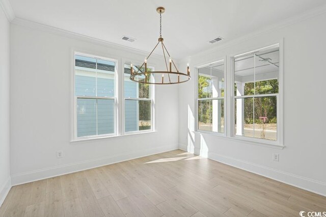 unfurnished room featuring ornamental molding, a raised ceiling, and light hardwood / wood-style floors