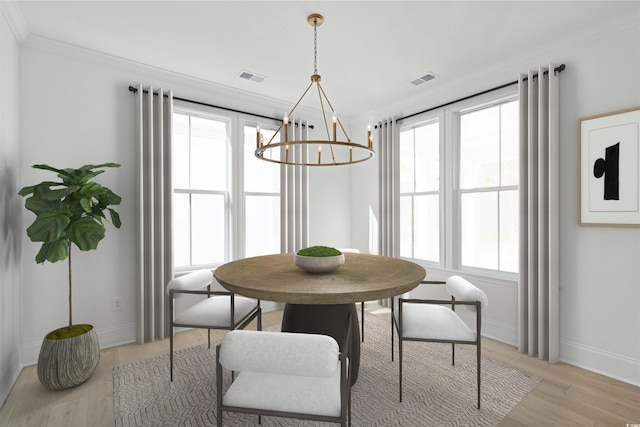 dining room with crown molding, baseboards, light wood-type flooring, and a chandelier