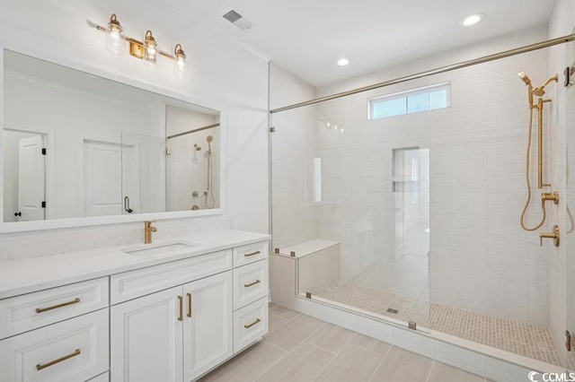 bathroom featuring visible vents, a shower stall, and vanity