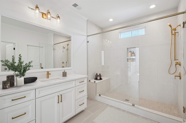 bathroom with visible vents, vanity, ornamental molding, and a shower stall
