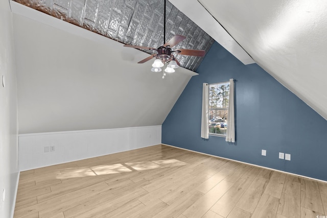 additional living space featuring ceiling fan, vaulted ceiling, and light hardwood / wood-style flooring