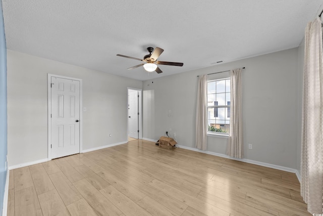 unfurnished room featuring ceiling fan, a textured ceiling, and light hardwood / wood-style floors