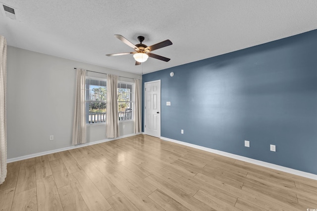 spare room featuring ceiling fan, a textured ceiling, and light hardwood / wood-style flooring