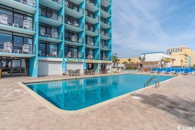 view of swimming pool featuring a patio area