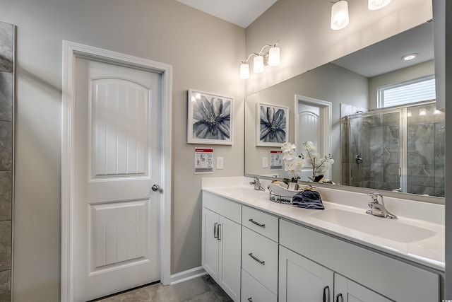 bathroom with tile patterned flooring, vanity, and a shower with shower door