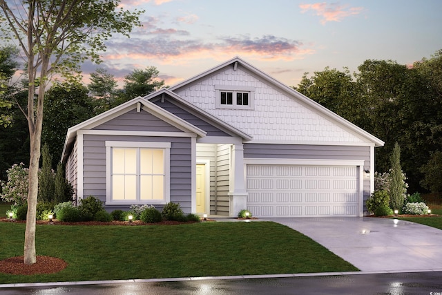 view of front of property with a yard and a garage