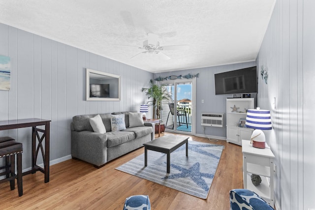 1919 Spring St Unit B-31, North Myrtle Beach, SC 29582 - living room with a textured ceiling, ceiling fan, heating unit, and light wood-style flooring