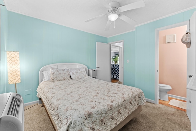 carpeted bedroom with heating unit, connected bathroom, ornamental molding, and ceiling fan