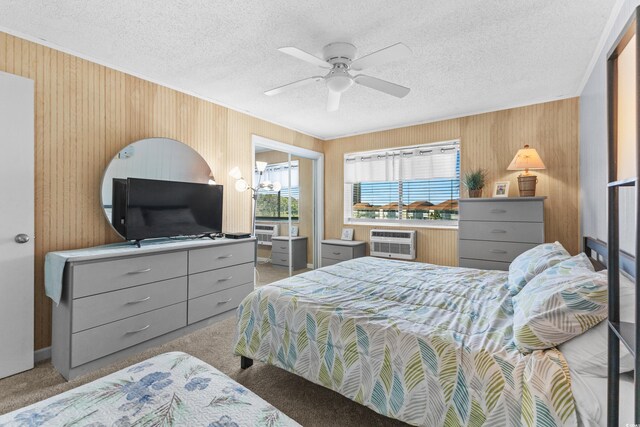 1919 Spring St Unit B-31, North Myrtle Beach, SC 29582 - bedroom featuring wooden walls, carpet flooring, ornamental molding, a textured ceiling, and an AC wall unit