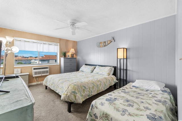 bedroom featuring ceiling fan, a textured ceiling, wooden walls, carpet floors, and a wall mounted air conditioner