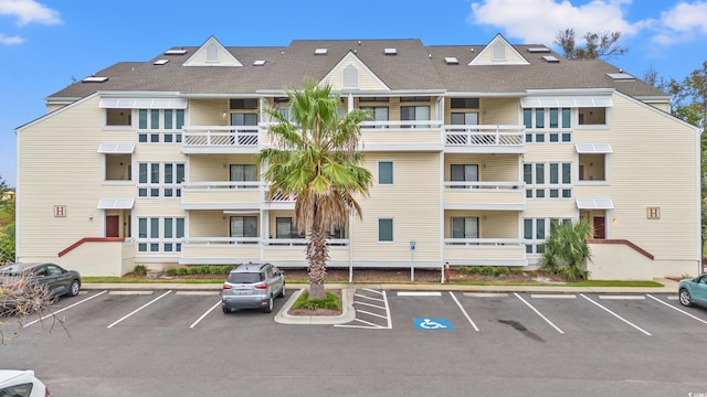 view of property featuring uncovered parking