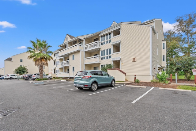 view of property featuring uncovered parking
