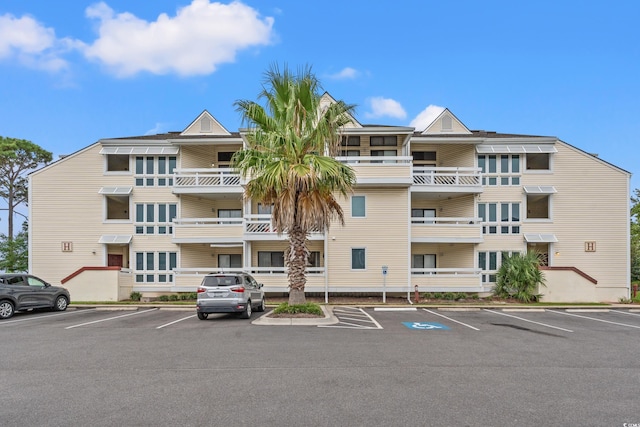 view of building exterior featuring uncovered parking